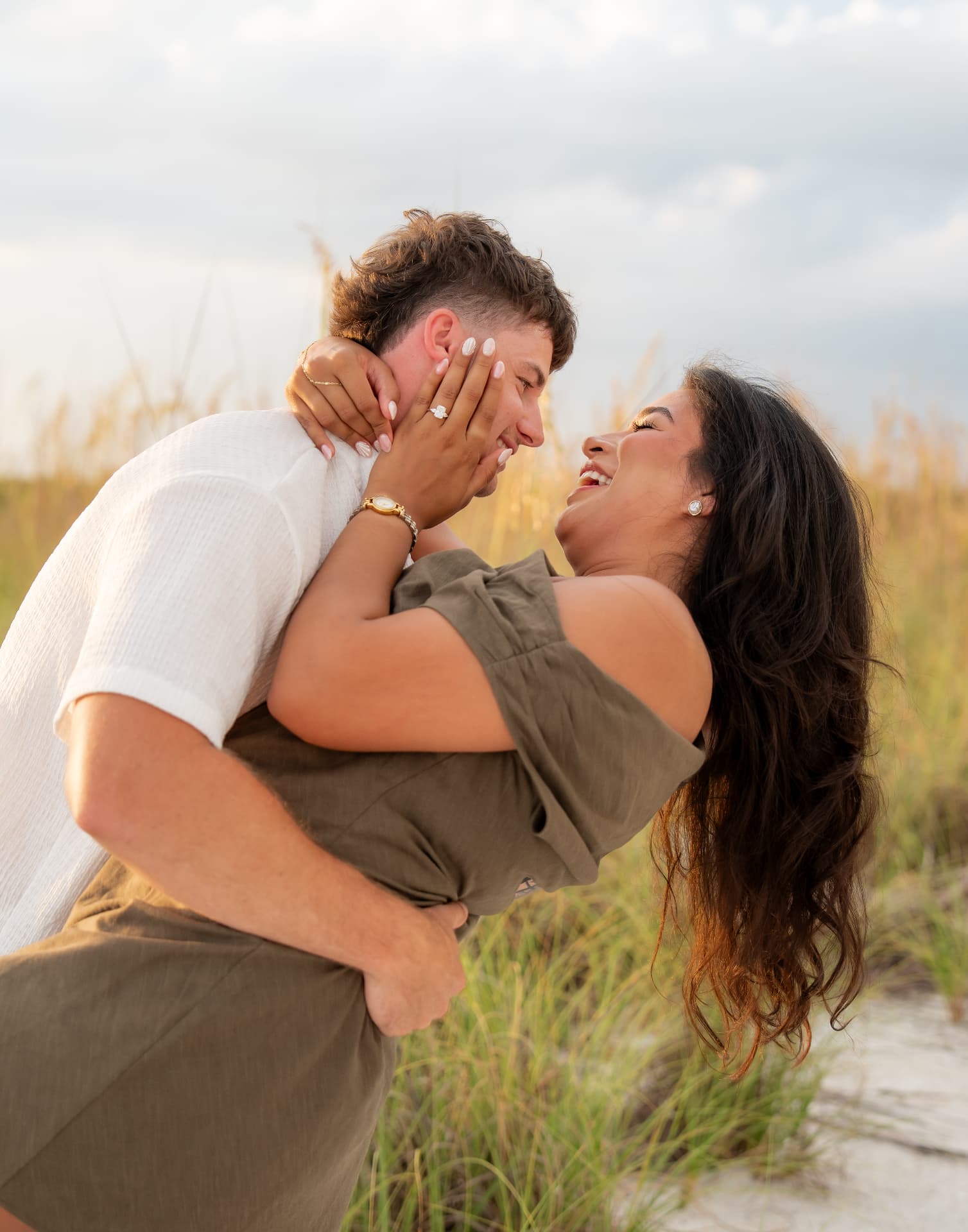 Engaged couple laughing along the shoreline in Naples, Florida